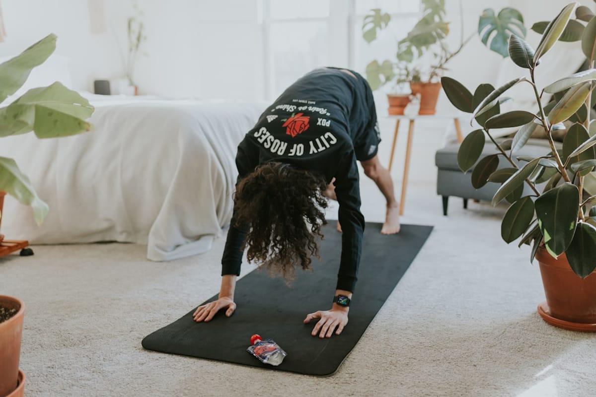 Incorporate Cardio Bursts | Woman working out in bedroom
