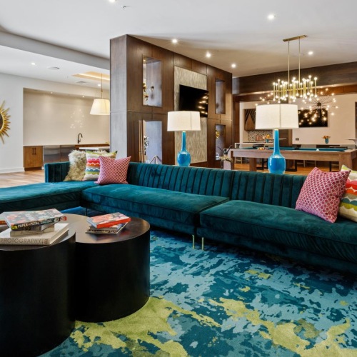 Thoughtful details to elevate your lifestyle a living room with a large chandelier and a large blue couch