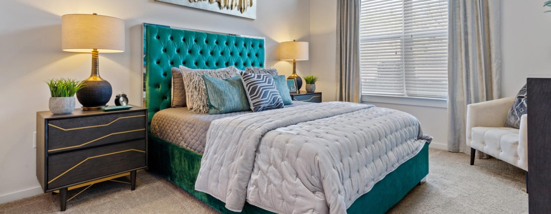 a bedroom with a bed and lamps