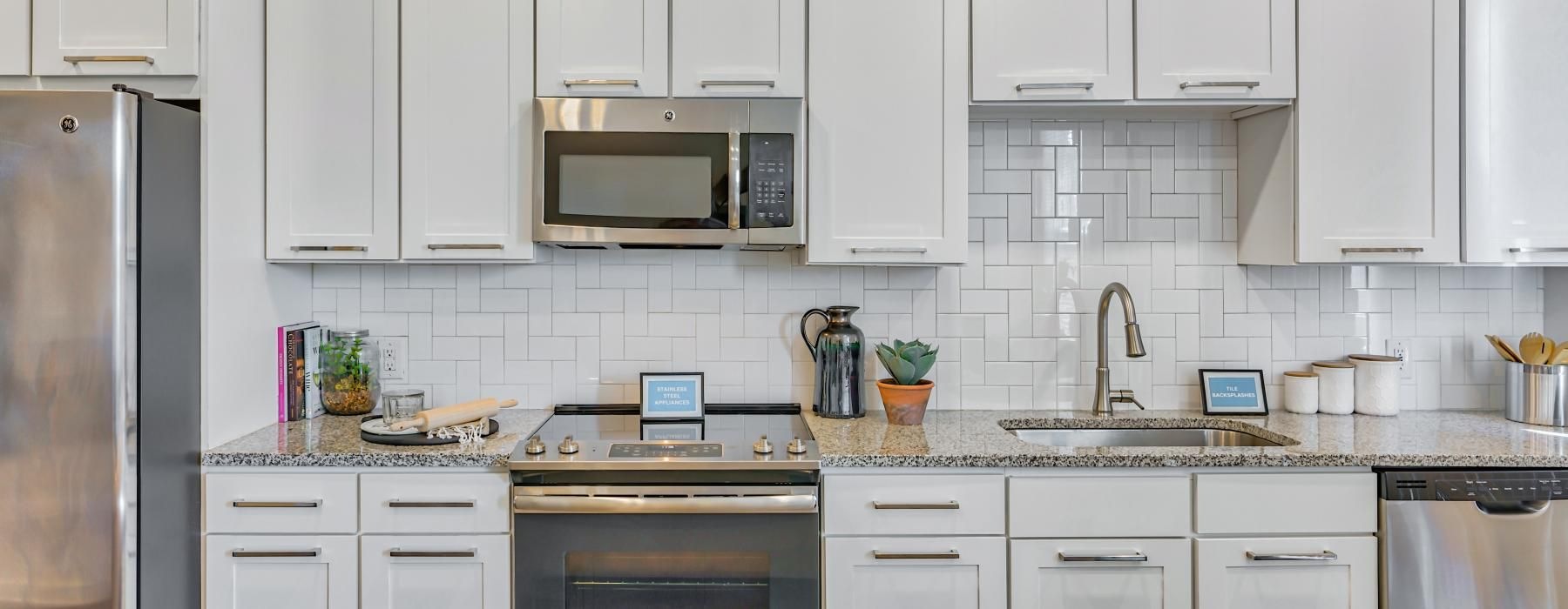 a kitchen with white cabinets