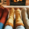 a pair of feet in front of a fireplace